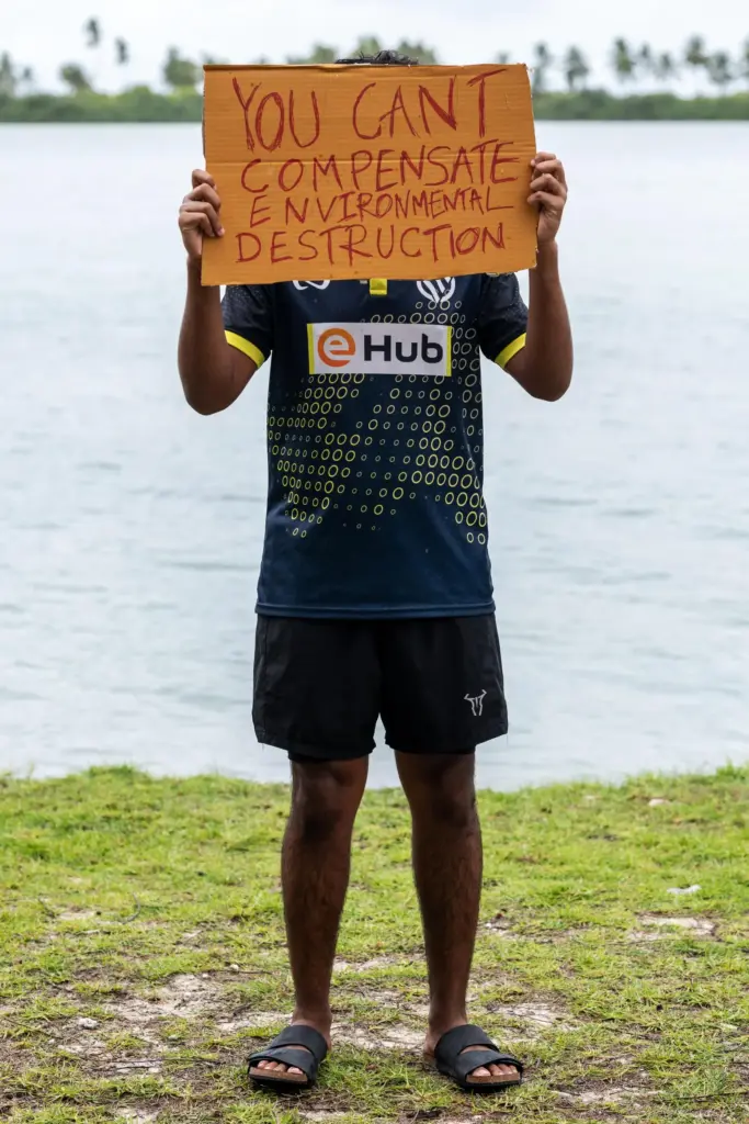A demonstrator holds a sign while participating in an action...