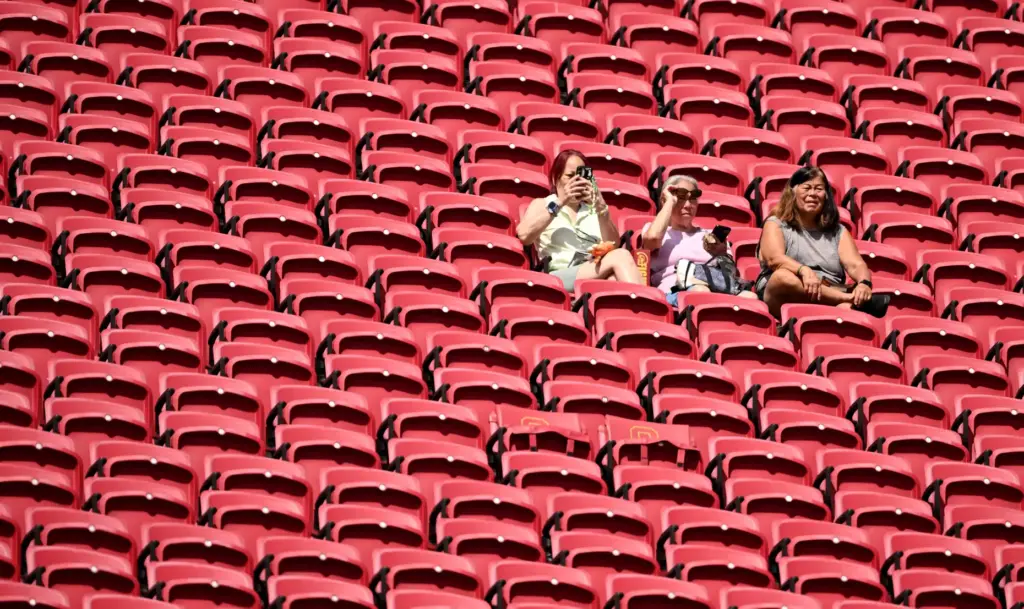 Football fans sit high up in the stadium prior to...