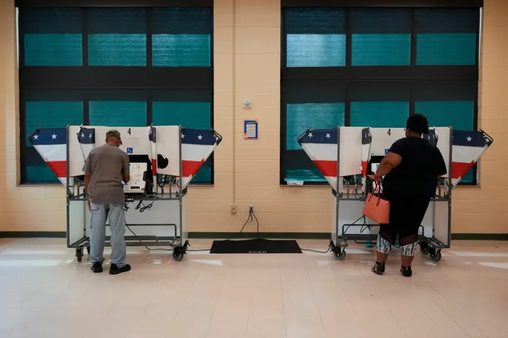 People vote at a polling place in a primary election...