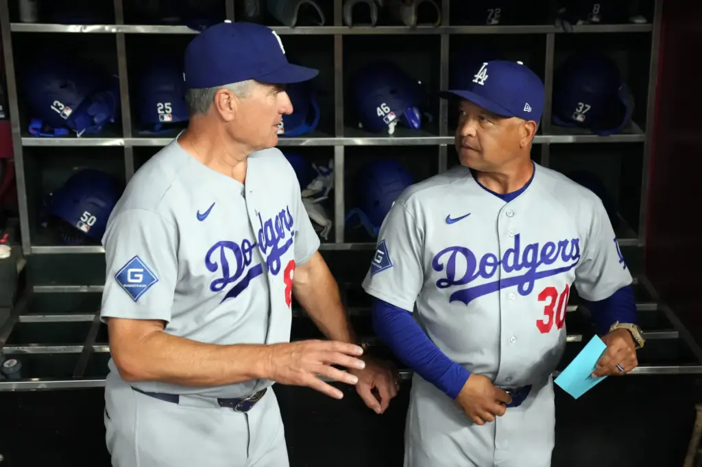 Dodgers coordinator Bob Geren, left, and manager Dave Roberts talk...
