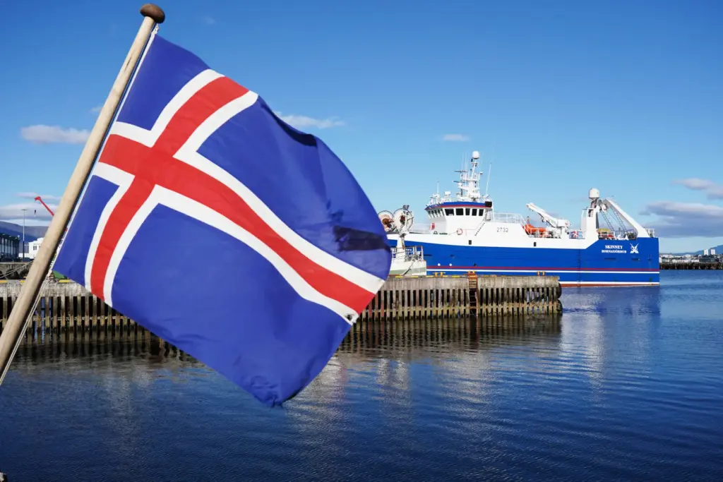 An Icelandic flag waves in the wind at Reykjavik Harbor...