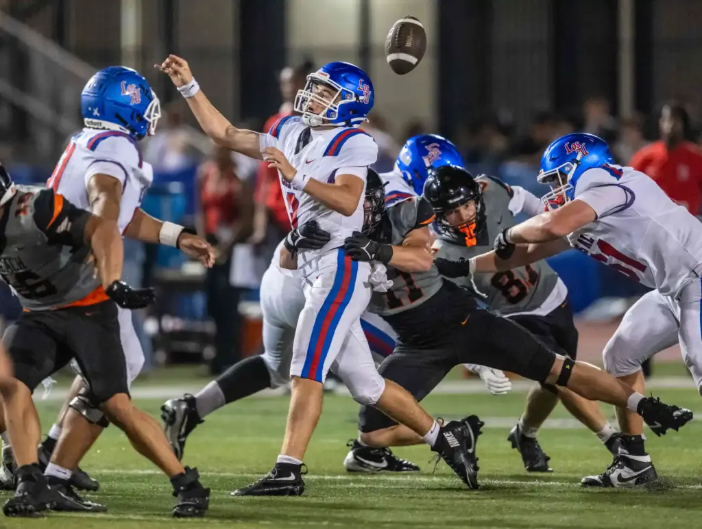 Huntington Beach defensive end Evan Scruggs (11) sacks Los Alamitos...