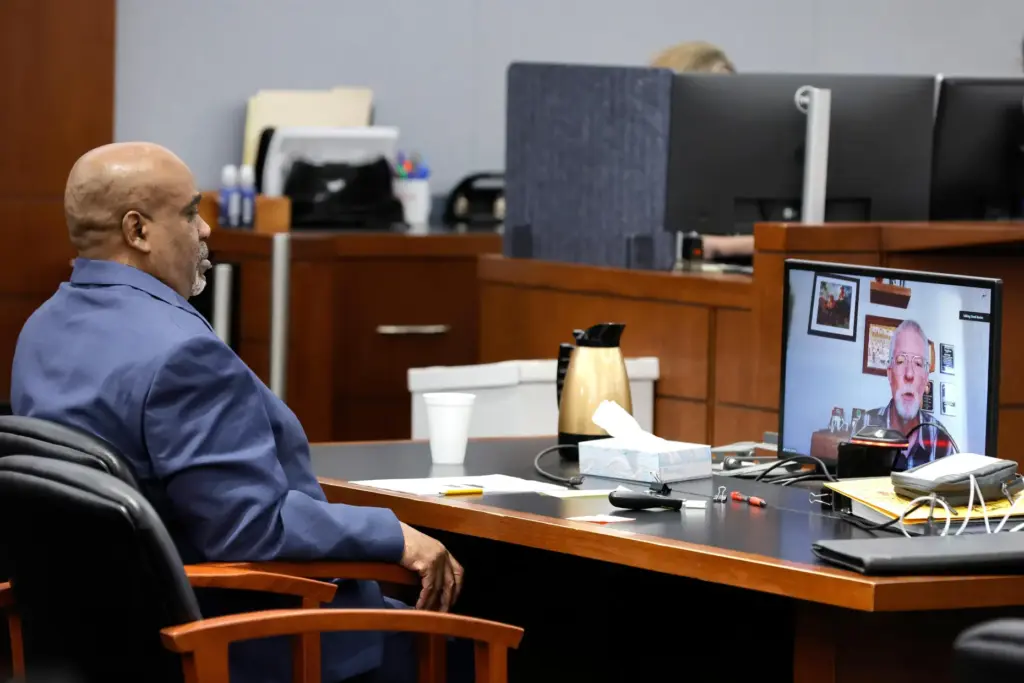 Duane Davis listens as Brent Becker testifies by video feed.
