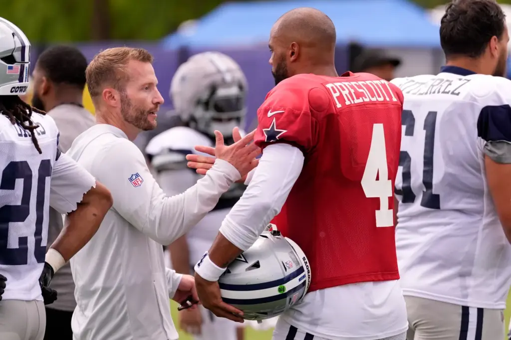Rams head coach Sean McVay, left, greets Dallas Cowboys quarterback...