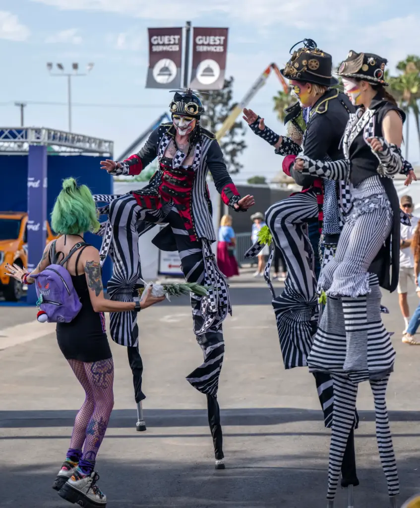 Steampunk stilt performers greet a fairgoer at the OC Fair...