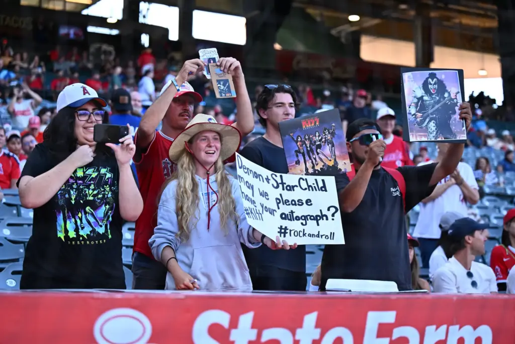 Fans of the band KISS show their signs before a...