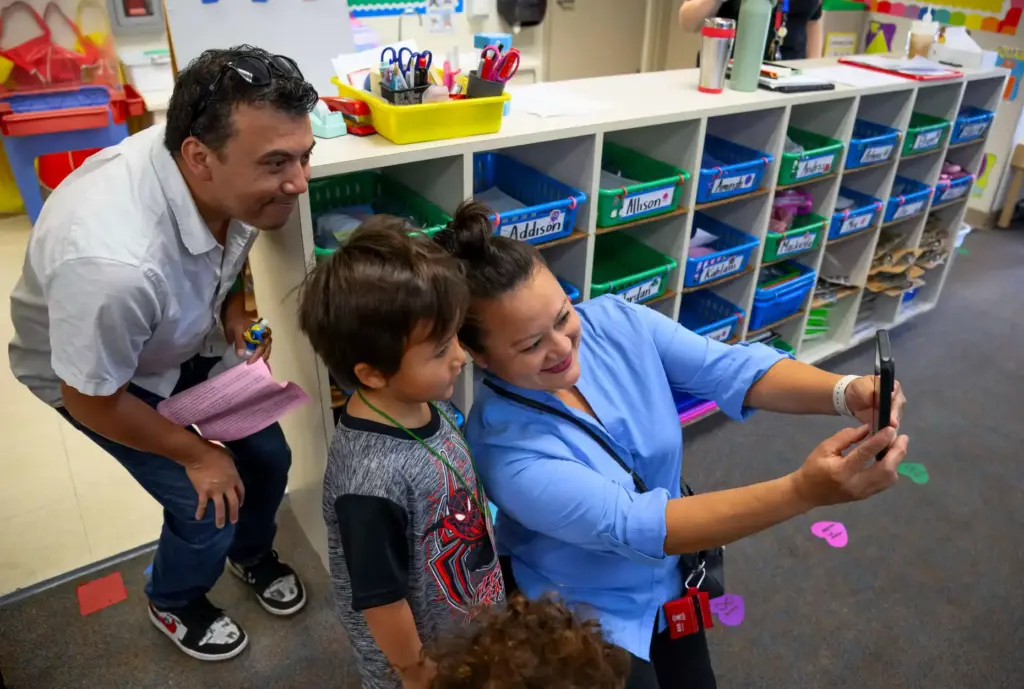 Cindy Morales, right, takes a selfie with husband Elias, left,...