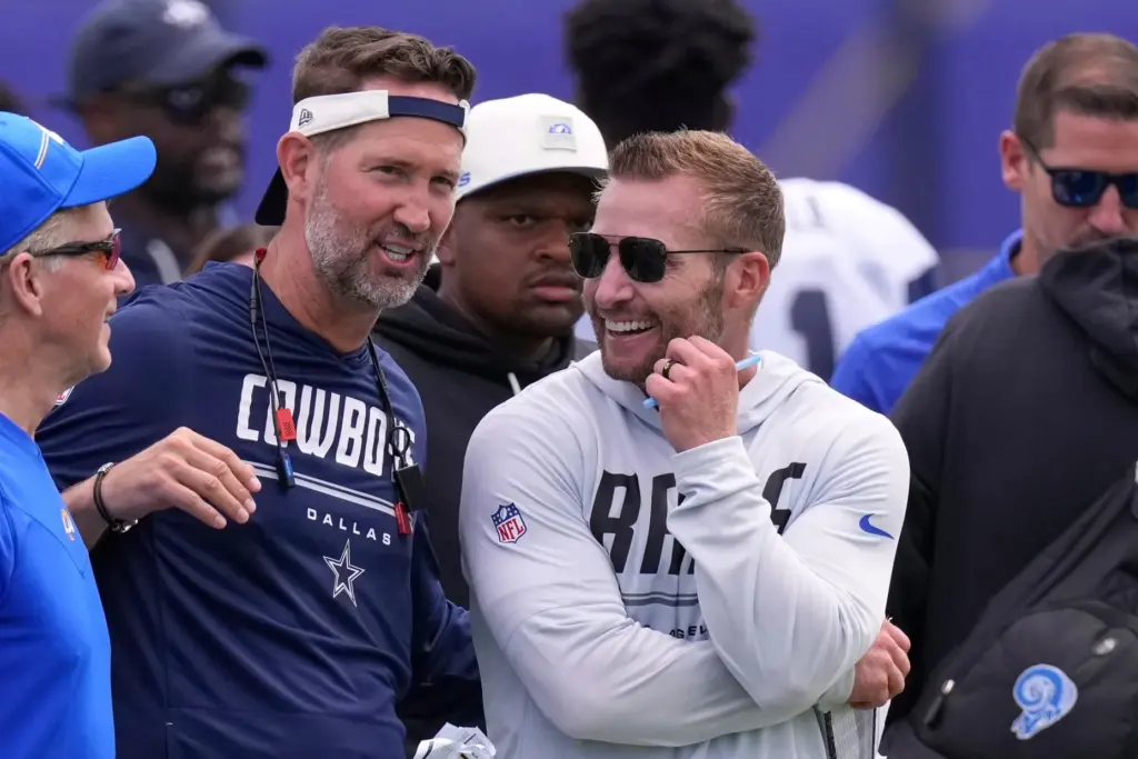 Dallas Cowboys head coach Brian Schottenheimer, center, talks with Rams...