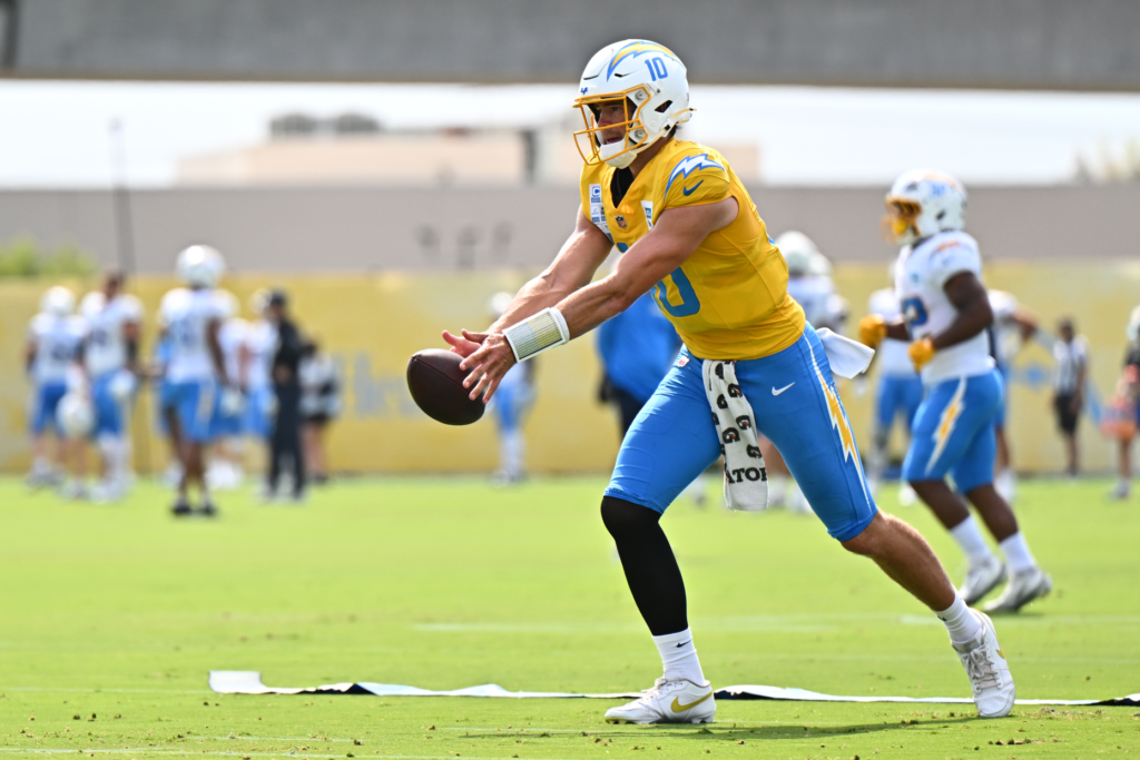 Chargers quarterback Justin Herbert runs a drill during a training...