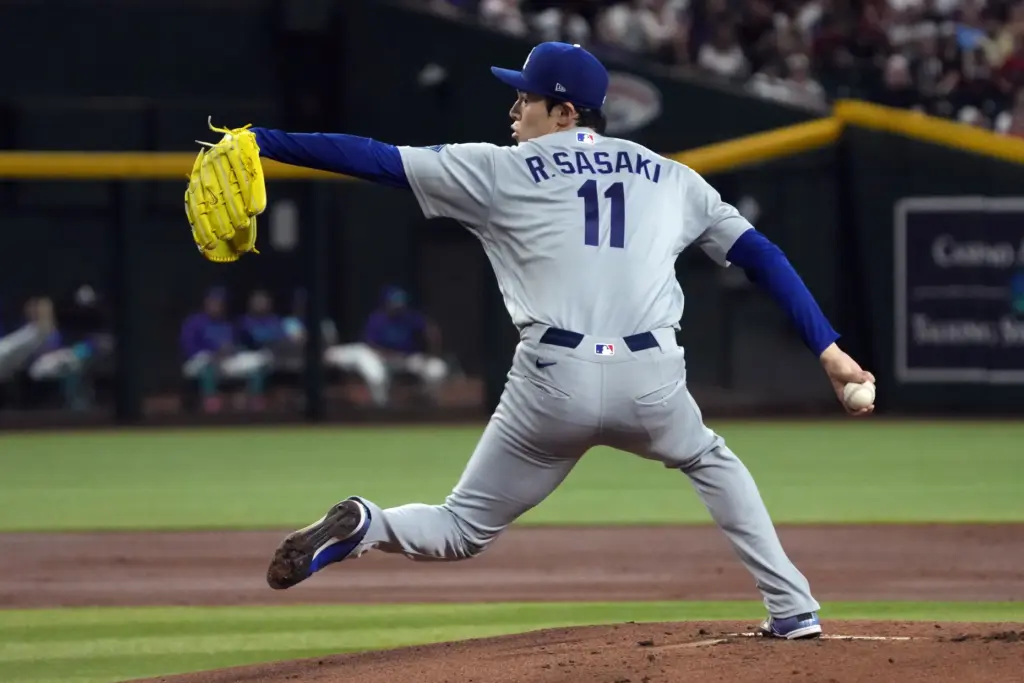 Dodgers starting pitcher Roki Sasaki throws to the plate during...