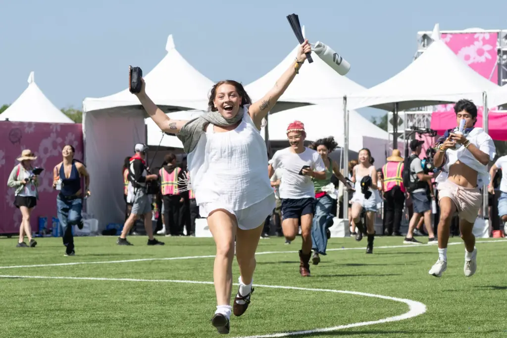 Festivalgoers run to the Dandelion Stage at the start of...