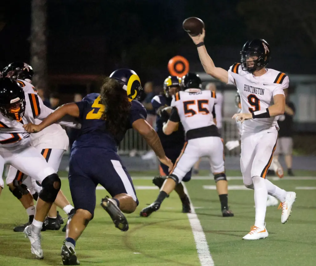 Millikans Karter Vaitagutu (9) tris to stop Huntington Beachs quarterback...