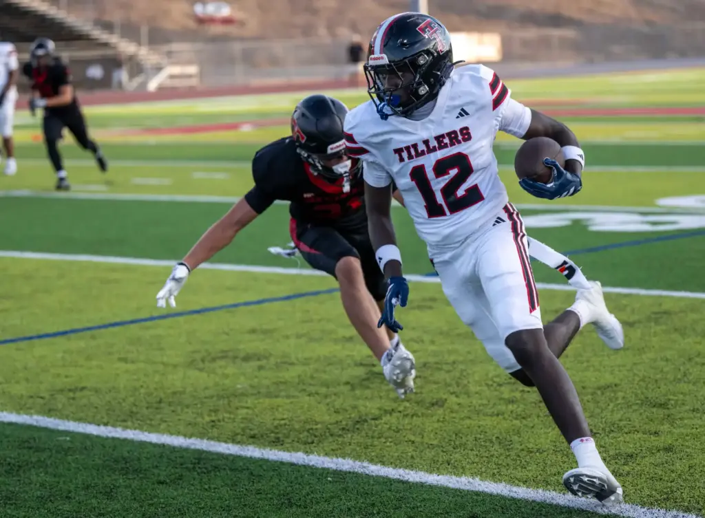 Tustin wide receiver Rufai Azeez (12) carries the ball during...