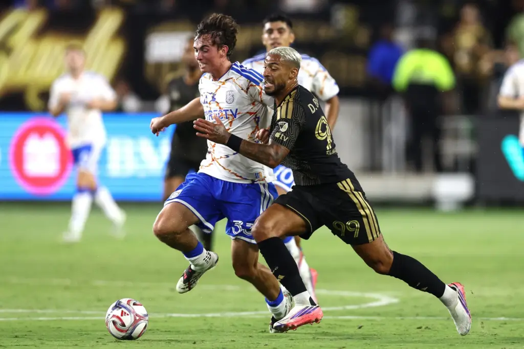 Los Angeles FC forward Denis Bouanga, right, battles for the...