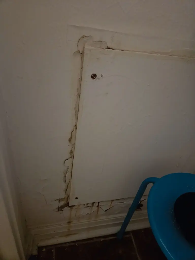 Water damage is seen on an interior access panel in the Hawkinsâ Fort Eustis home.