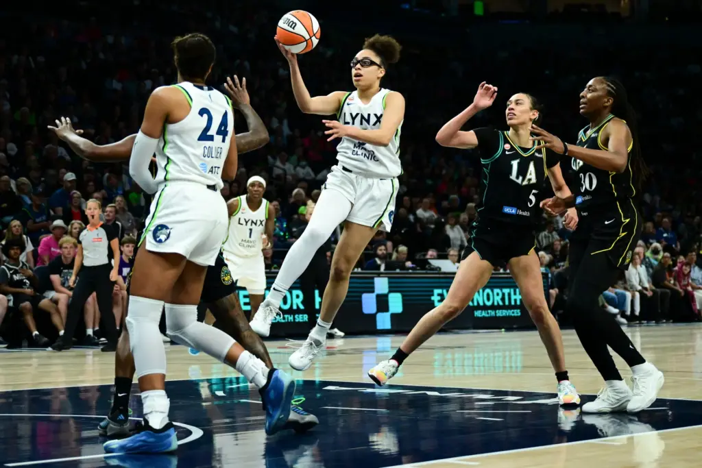 Minnesota Lynx guard Olivia Miles, center, fakes a layup before...