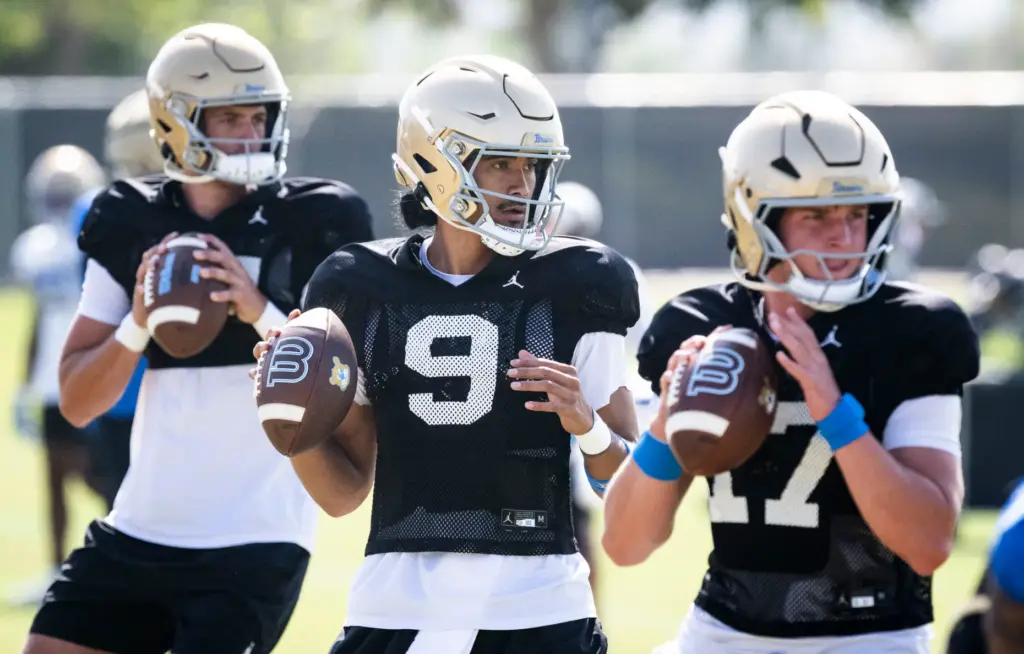 UCLA quarterback Nico Iamaleava (9), goes through drills with teammates...