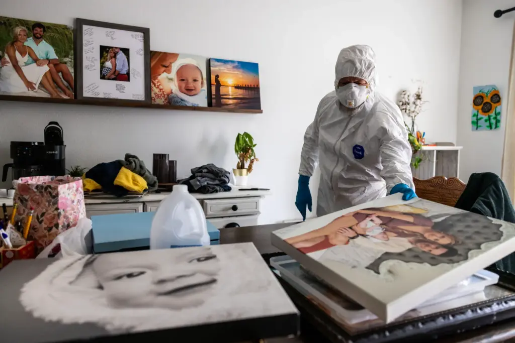 Stephen Barrett moves family photos before removing the hand-made kitchen...