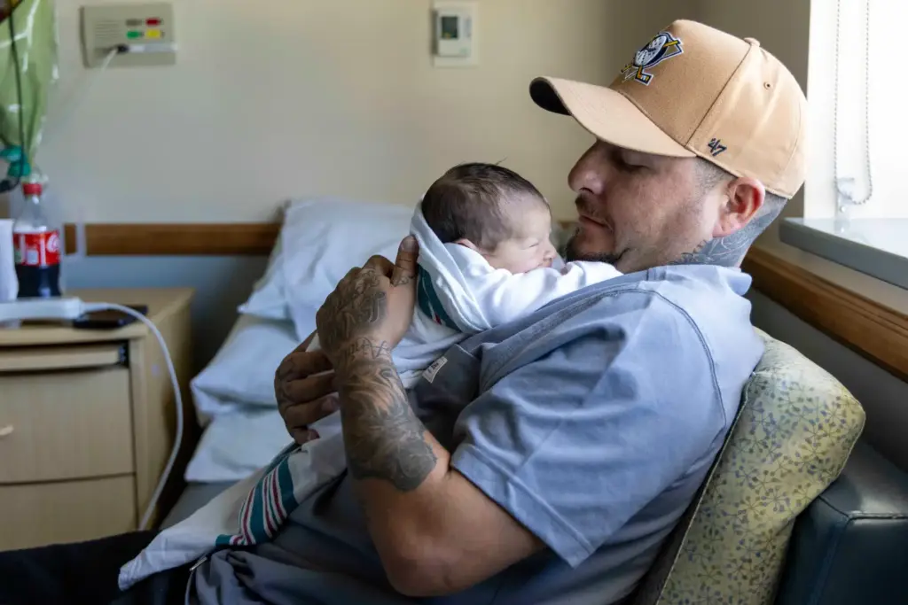 Jaciel Marcavo holds his newborn daughter on Thursday, Aug. 6,...