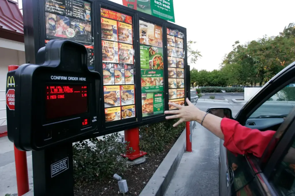 A customer orders a meal at a drive-thru at McDonald's restaurant.