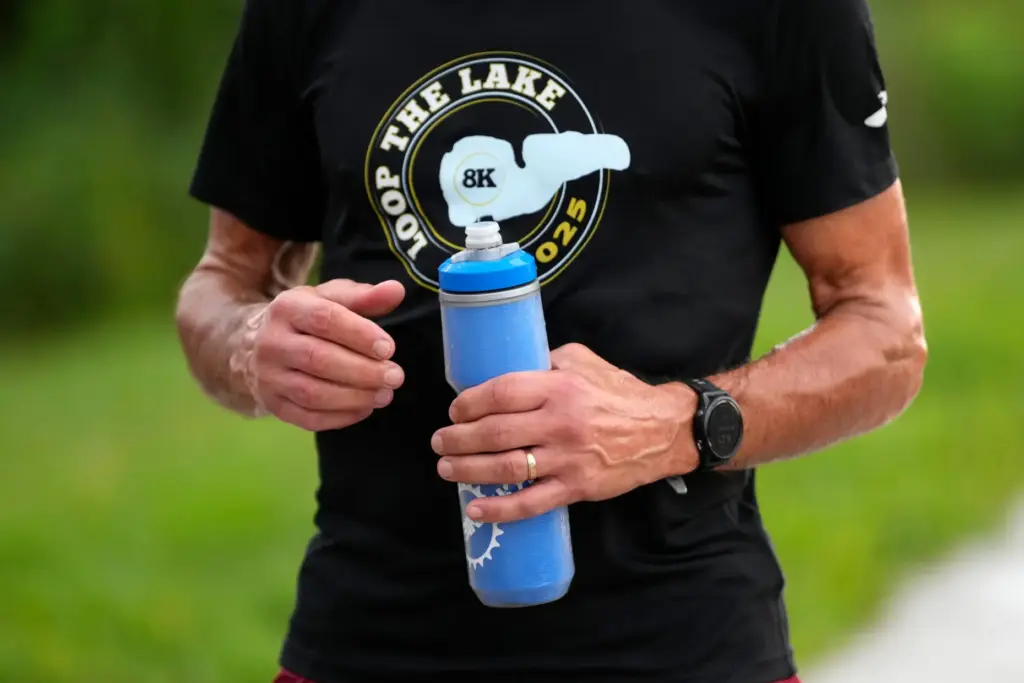 Paul Grinvalds holds a water bottle after a run with the Raccoon River Running Club.