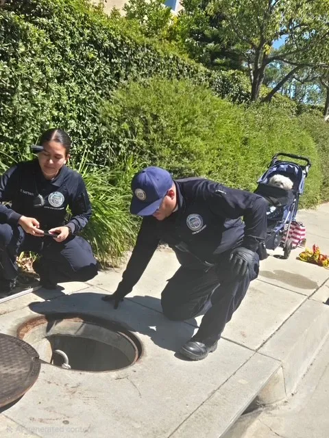 Rescuers work in the Gardena storm drain where neighbors heard...