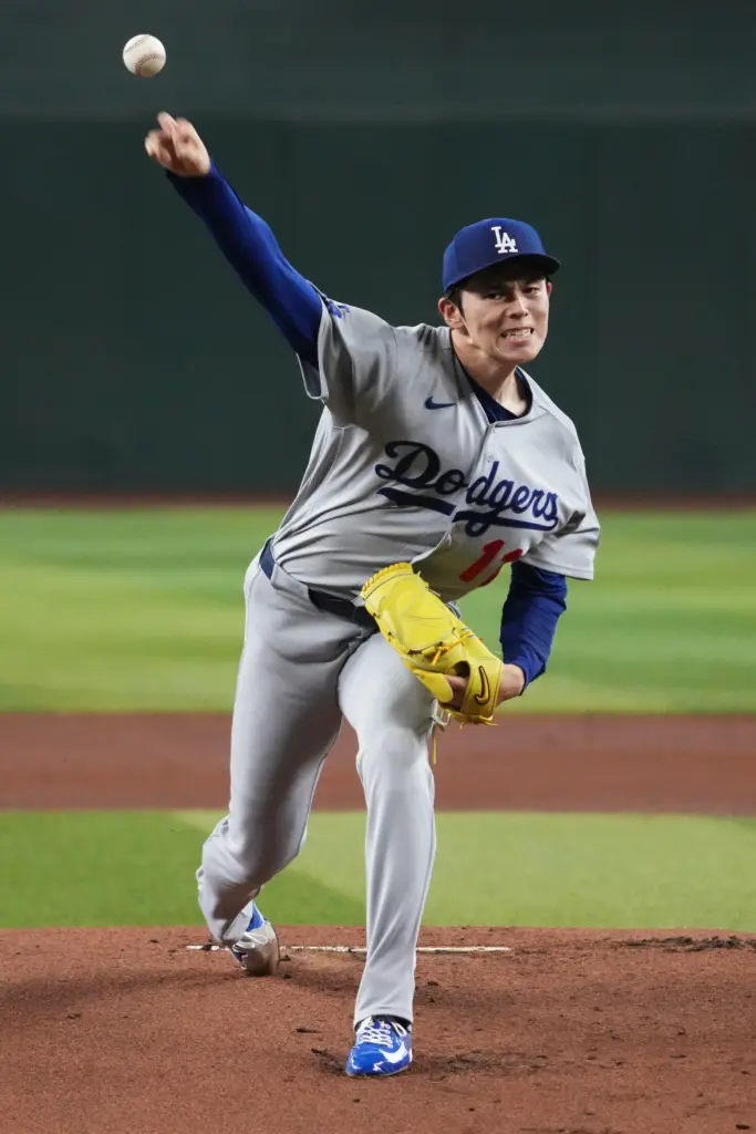 Dodgers starting pitcher Roki Sasaki throws to the plate during...