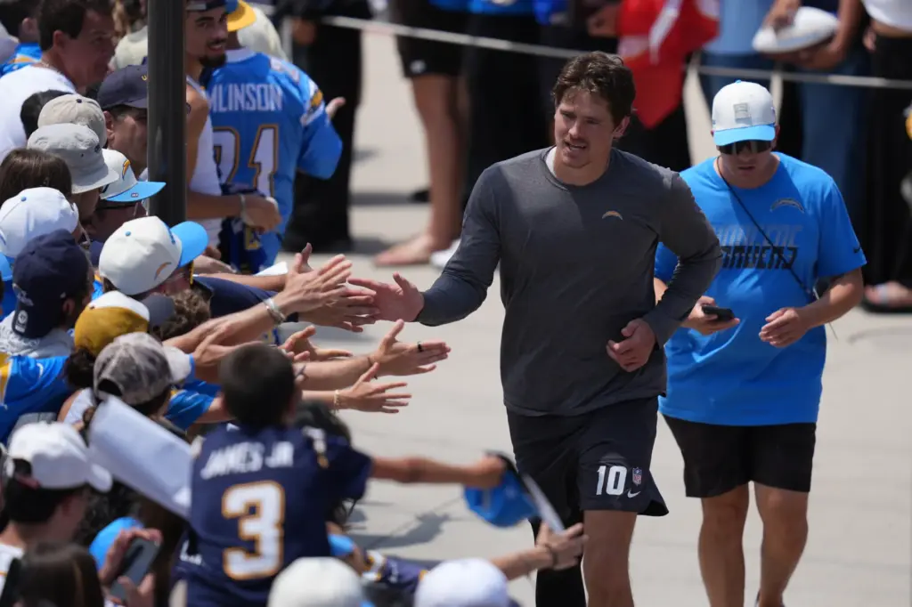 Chargers quarterback Justin Herbert greets fans during an NFL football...