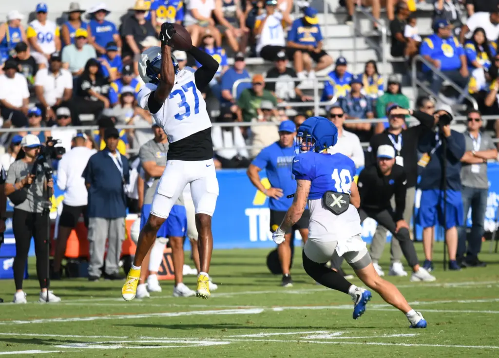 Rams safety Quentin Lake, left, intercepts a pass from Stetson...