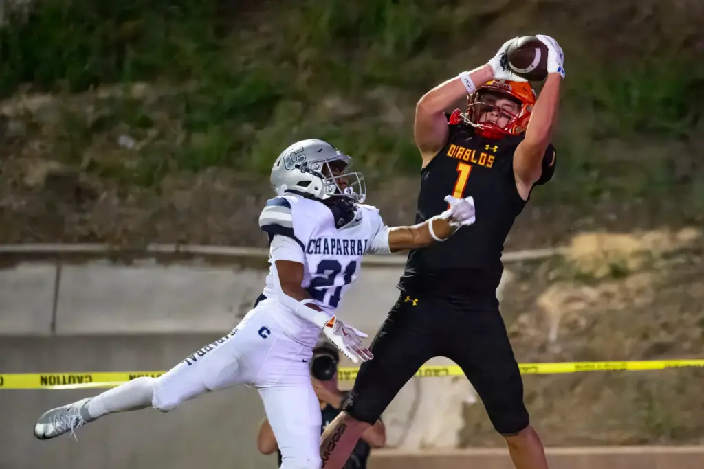 Mission Viejo wide receiver Luke Karby, right, reaches above Chaparral...