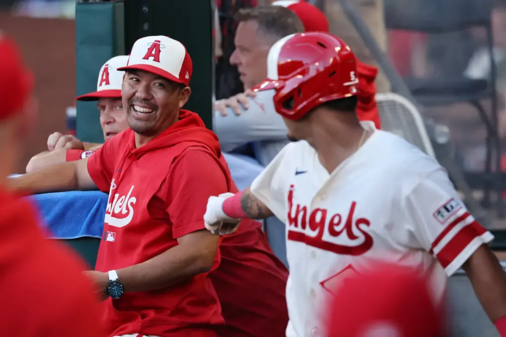 Angels manager Kurt Suzuki, left, celebrates with Vaughn Grissom, right,...
