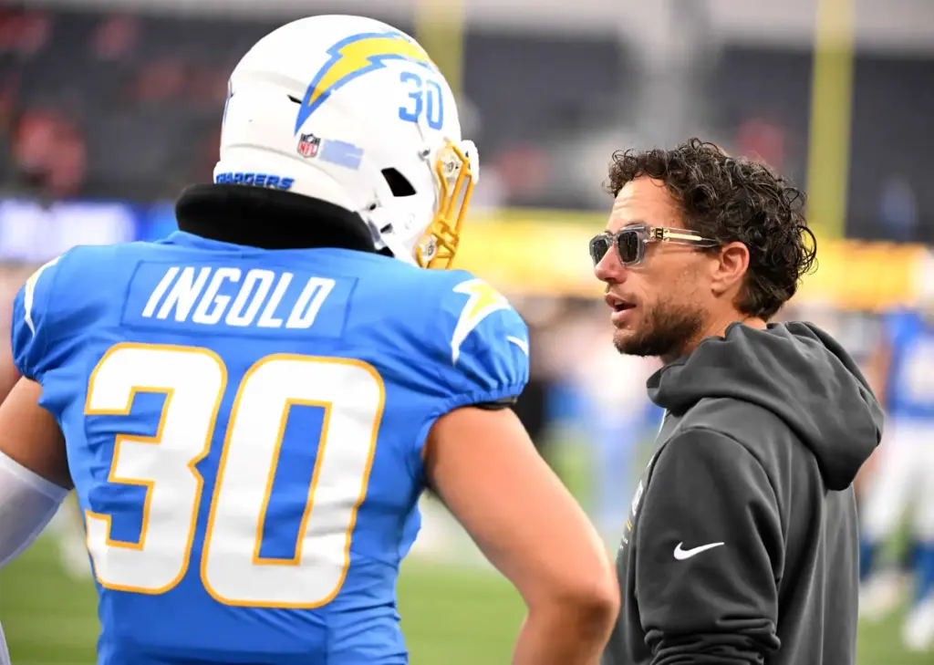 Chargers offensive coordinator Mike McDaniel talks to fullback Alec Ingold...