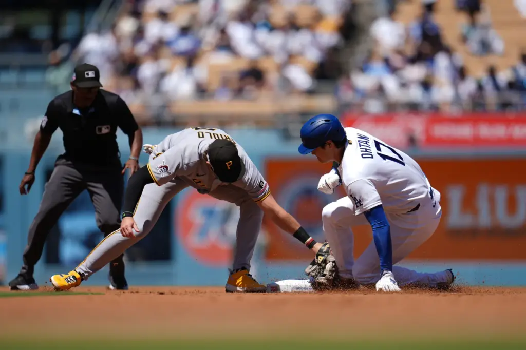Dodgers’ Shohei Ohtani, right, steals second base during the first...
