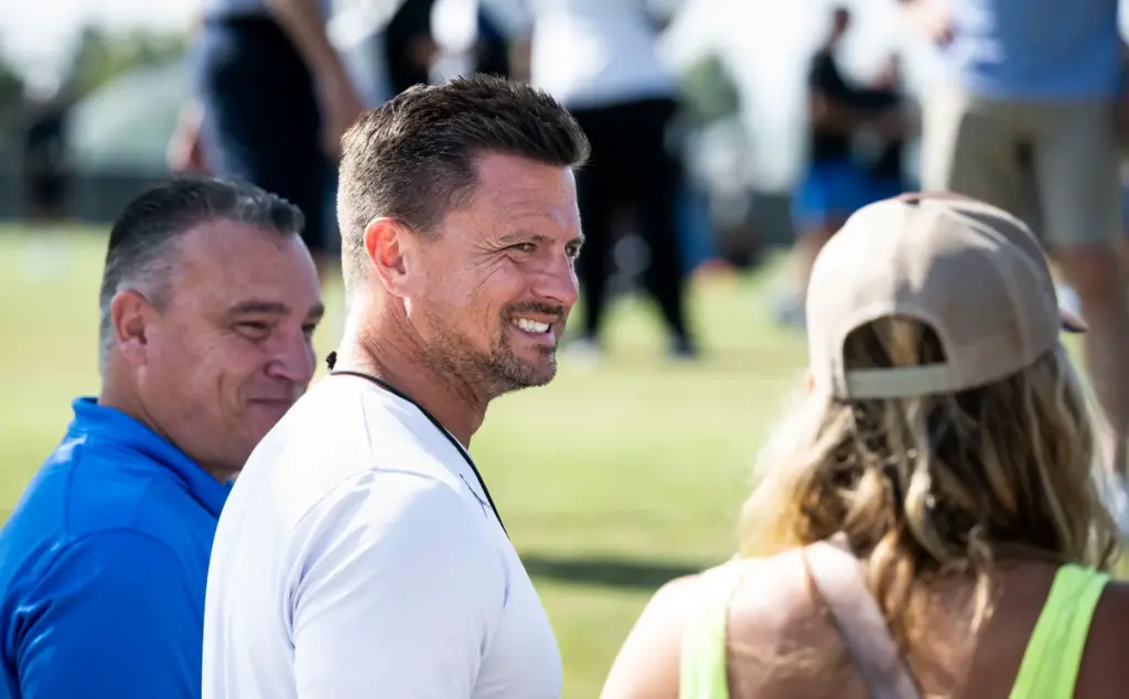 UCLA head coach Bob Chesney talks to fans before the...