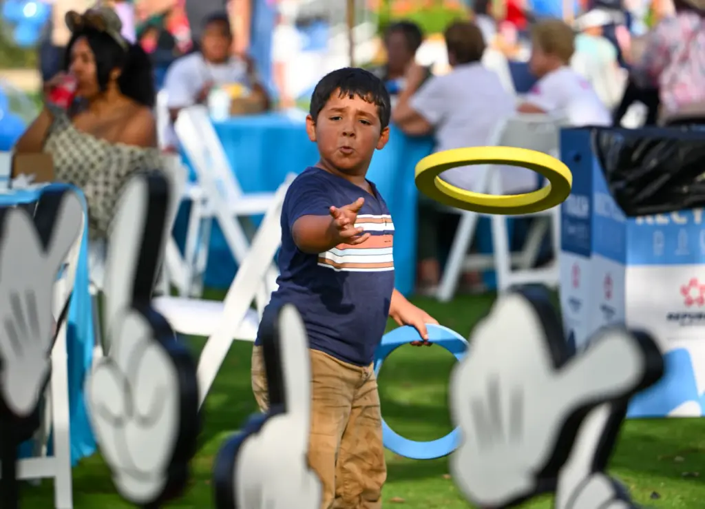 Julian Ureno, 6, throws rings around cartoon hands during Disneyâs...