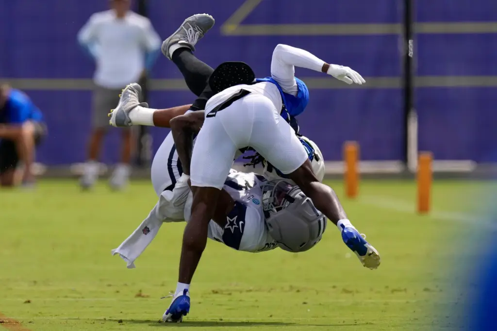 Rams cornerback Cam Lampkin, top, and Dallas Cowboys tight end...