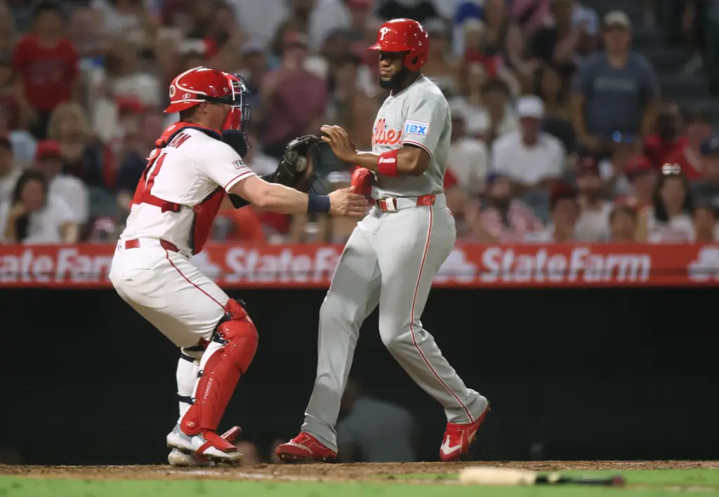 Angels catcher Tyler Heineman, left, tags the Philadelphia Phillies’ Bryan...