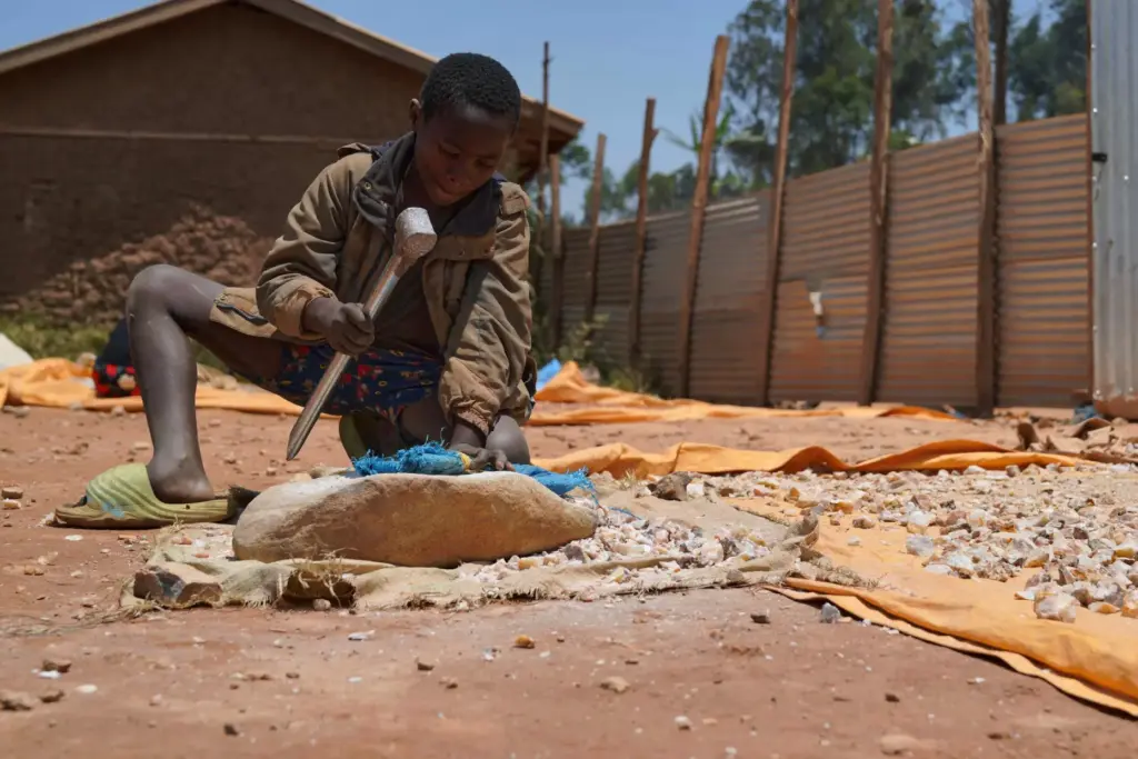 Isaac Batisa, 11 years old, searches for gold at a mining site in Iga-BarriÃ¨re, Congo.