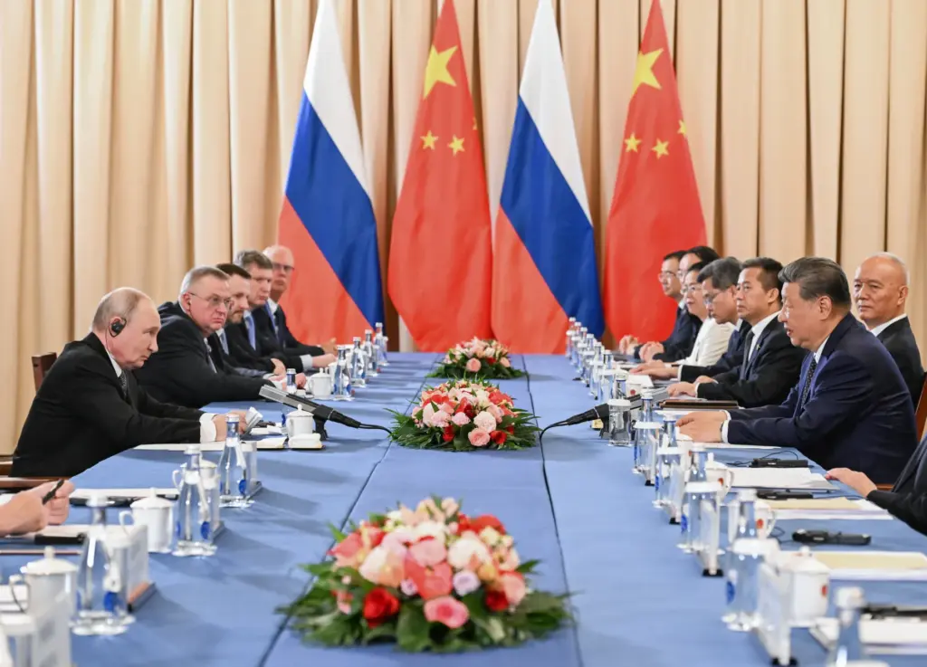 Russian President Vladimir Putin and China's President Xi Jinping attend a meeting.