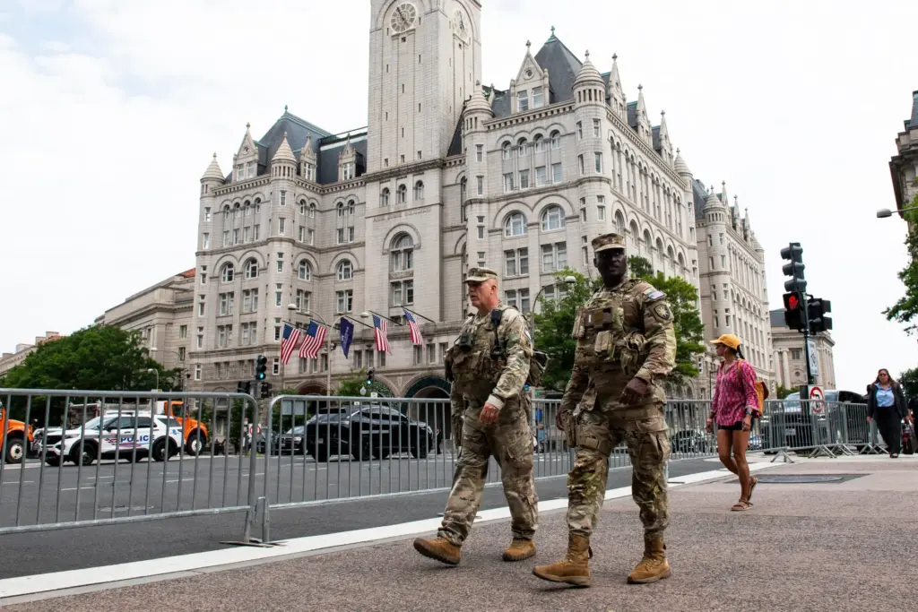 National Guard troops walk across the street from the Waldorf...