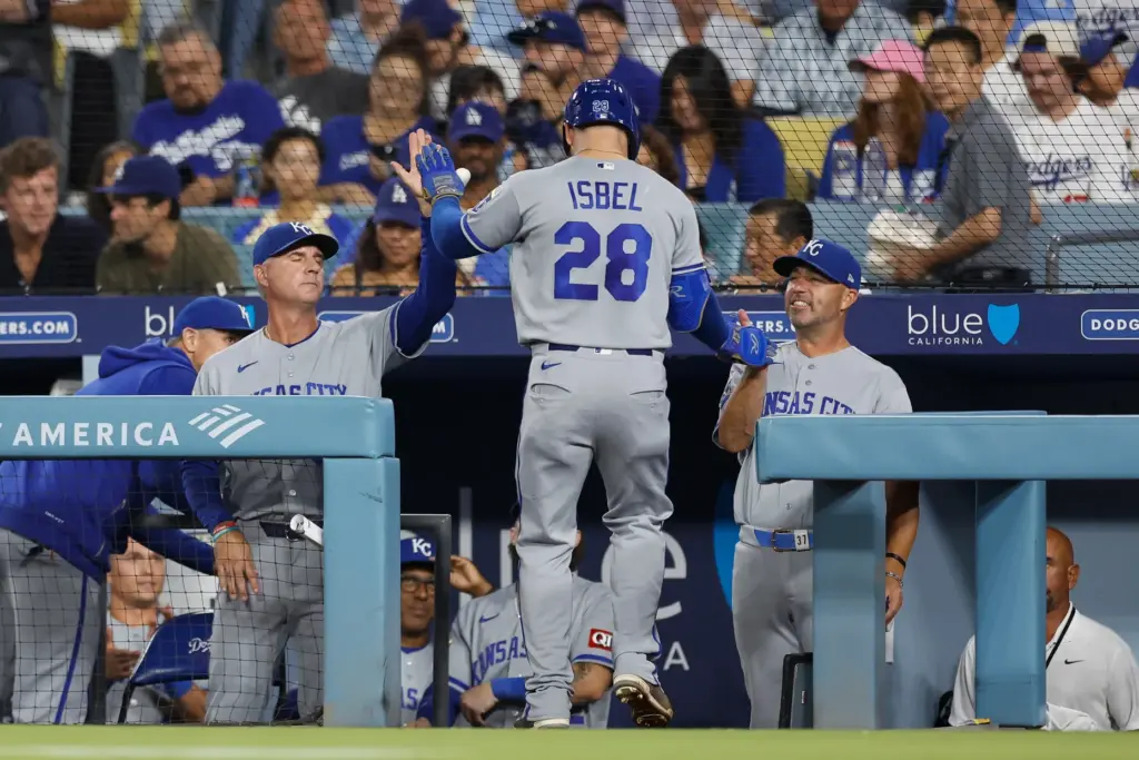 The Kansas City Royals’ Kyle Isbel is greeted by teammates...