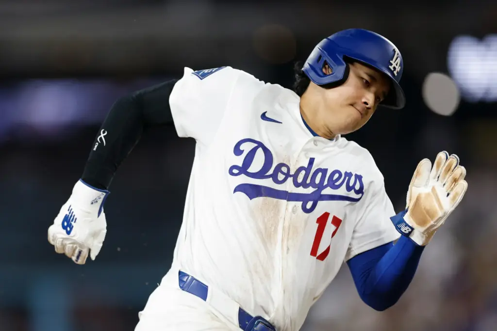 Dodgers star Shohei Ohtani rounds third base on his way...