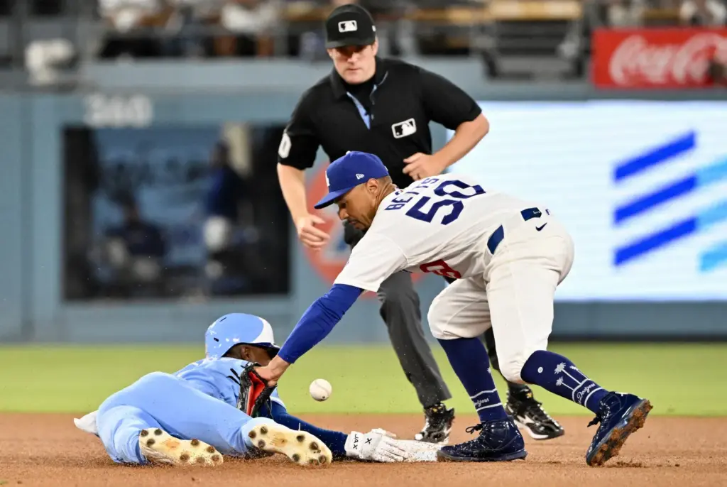 The Kansas City Royals’ Tyler Tolbert, left, steals second base...