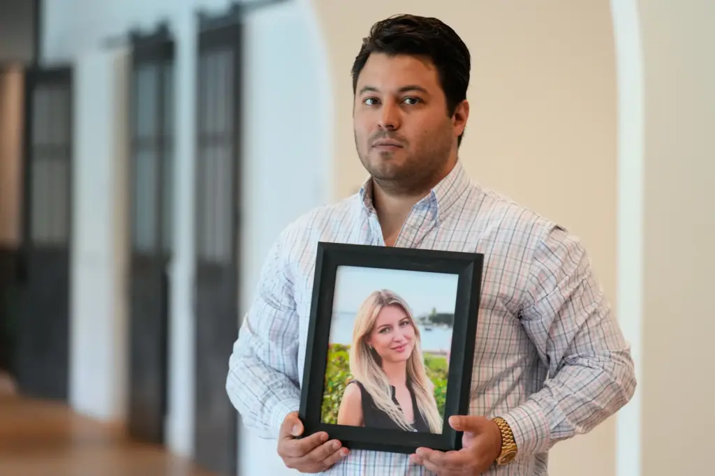 Harold Jezler poses for a picture with a photo of...