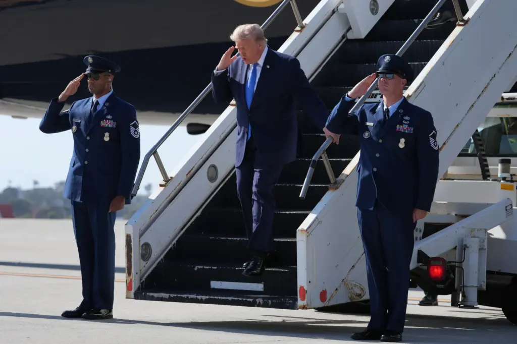 President Donald Trump arrives on Air Force One, Tuesday, Aug....