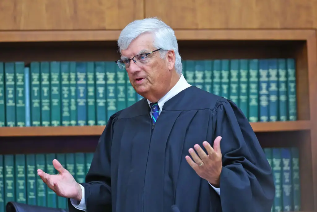 Justice William Sullivan informs the jury that the defense will start making their case.
