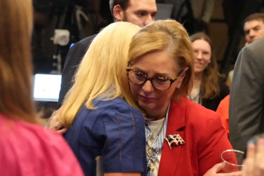 Sen. Darline Graham, R-S.C., right, receives a hug from Tara Spicer.