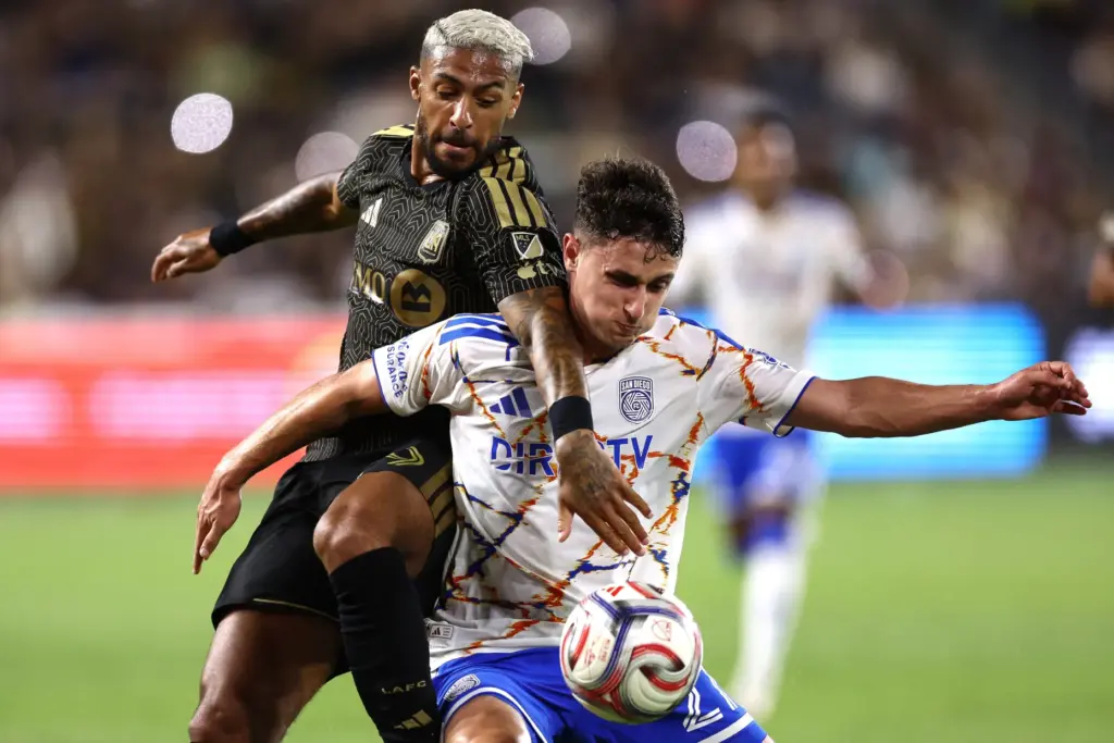 Los Angeles FC forward Denis Bouanga, left, battles for the...