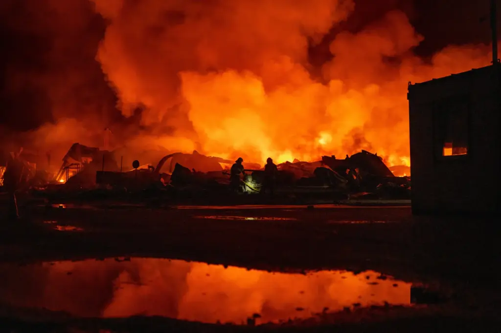 Firefighters put out a fire after Russian missiles hit a warehouse in Kyiv, Ukraine.