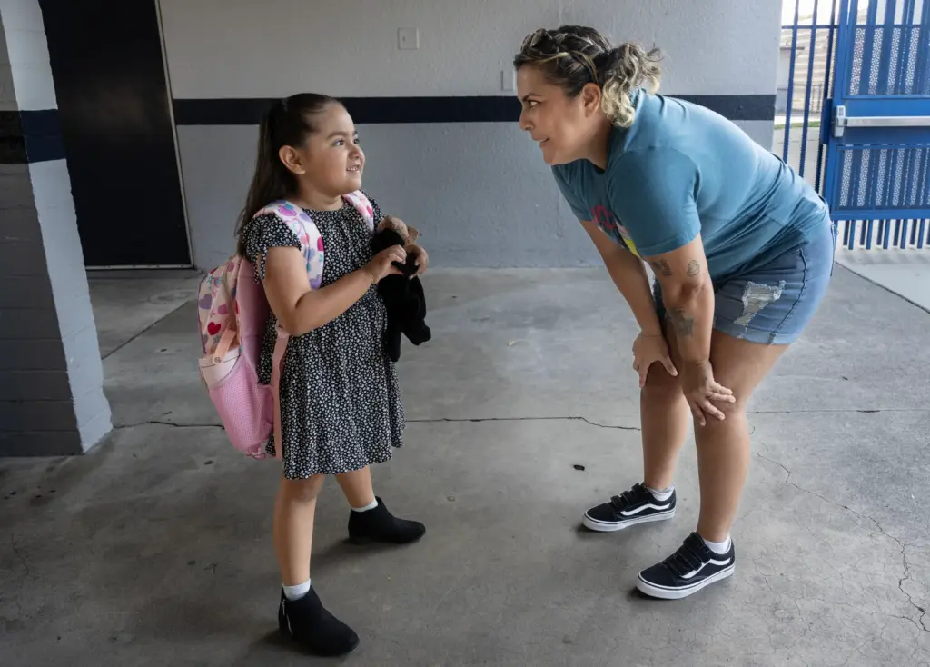Pacific Drive Elementary teacher aide Carla Barajas chats with former...